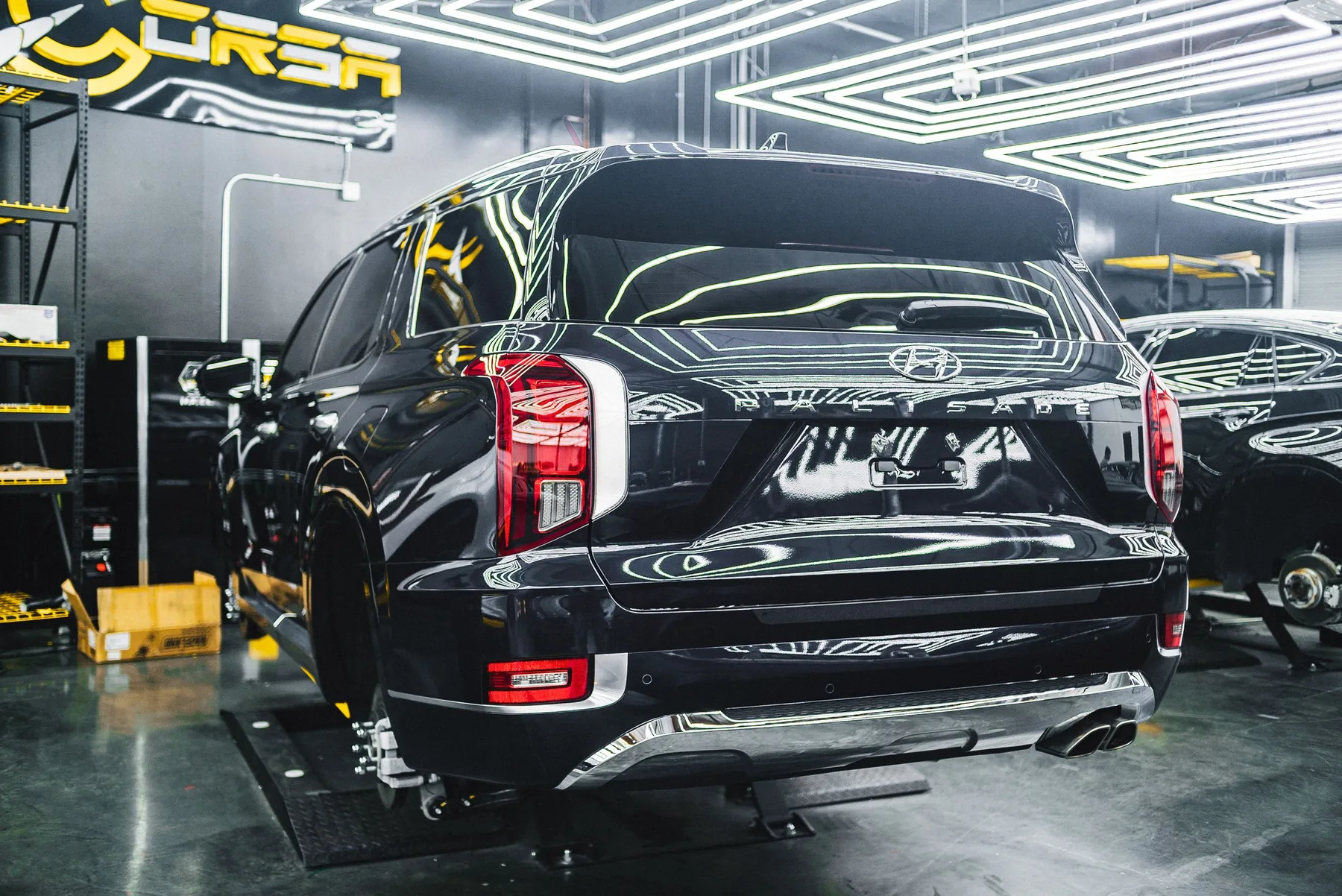 A car raised on the workshop ramp for inspection
