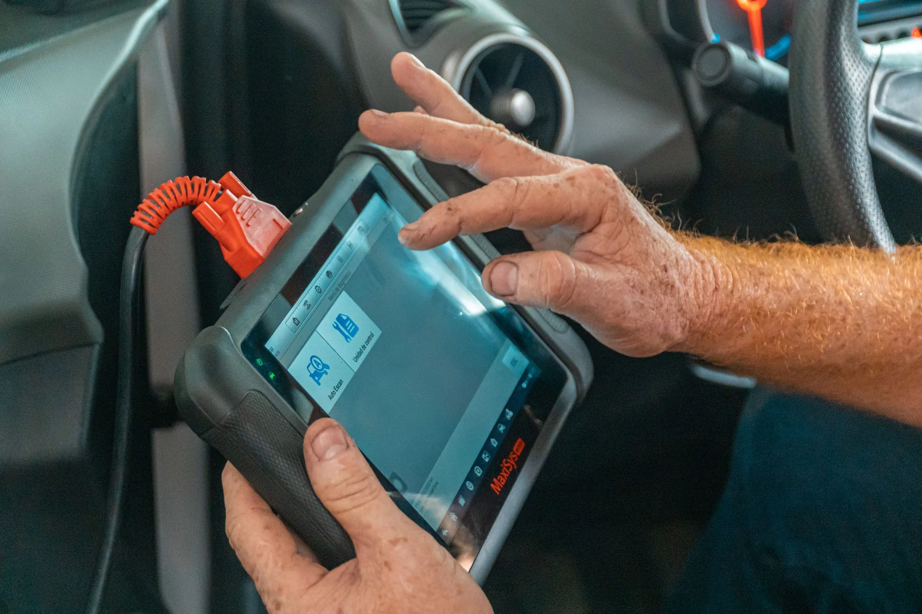 A diagnostic scanner plugged into a car's OBD port