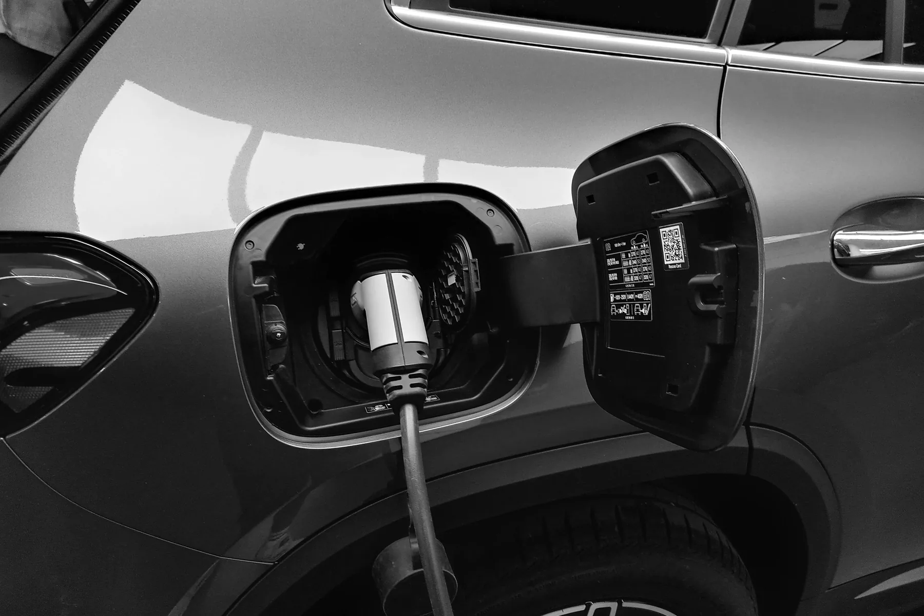 A hybrid car plugged in on charge