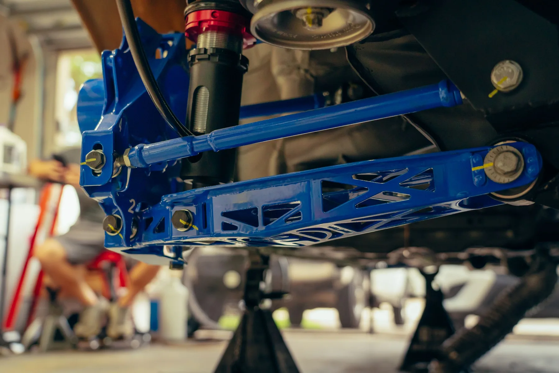 A coil spring and shock absorber suspension assembly
